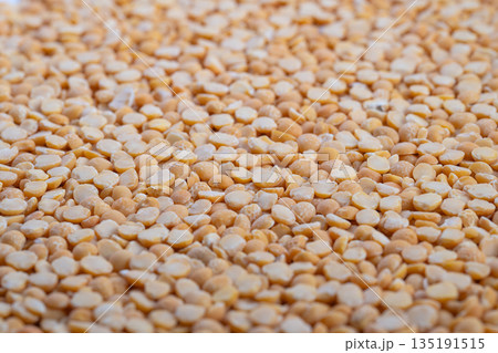 Industrial split peas closeup, processing line context with quality control narrative, bulk handling and packaging considerations, neutral lighting for product inspection theme Industrial split peas closeup, processing line context with quality control narrative, bulk handling and packaging considerations, neutral lighting for product inspection theme 135191515