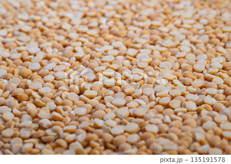Split peas texture, Organic split peas for nourishing vegan dishes and soups, Natural textured legumes with warm colors ideal for healthy plantbased recipes and meal preparation 135191578