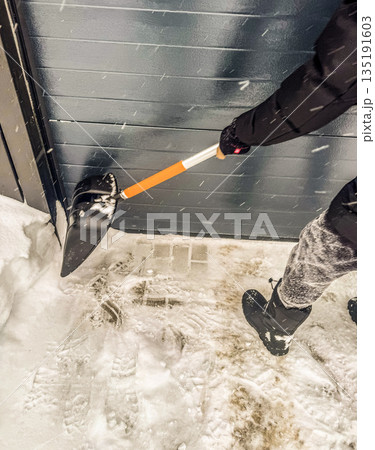 Clearing Snow from a Garage Door 135191603