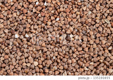 Buckwheat kernels showcase, Rustic dry husks highlight textures, Artisanstyle imagery captured with warm tones, Closeup of buckwheat showing detailed husks and coarse texture Buckwheat kernels showcase, Rustic dry husks highlight textures, Artisanstyle imagery captured with warm tones, Closeup of buckwheat showing detailed husks and coarse texture 135191655