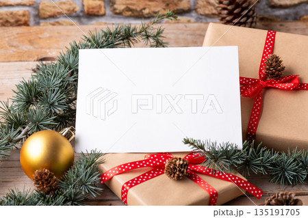 Christmas 7x5 card mockup template with fir twigs and Christmas decoration Christmas 7x5 card mockup template with fir twigs and Christmas decoration 135191705