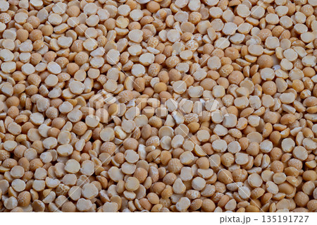 Peas ready cooking, Yellow peas for soup, Stack of yellow split peas used for soup preparation, Detailed view of yellow split peas stored in kitchen for meal making Peas ready cooking, Yellow peas for soup, Stack of yellow split peas used for soup preparation, Detailed view of yellow split peas stored in kitchen for meal making 135191727