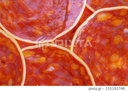 Juicy chorizo slices radiating warm tones and spice, glossy surface with visible seasonings, homey snack feeling, rich umami suggestion, high saturation and appetizing detail Juicy chorizo slices radiating warm tones and spice, glossy surface with visible seasonings, homey snack feeling, rich umami suggestion, high saturation and appetizing detail 135191746