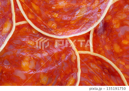 Circular chorizo arrangement highlights textures and appeal, Artistic flat arrangement of chorizo slices emphasizing marbling and cheese details for promotional use 135191750