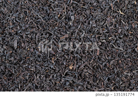 Tea tasting cupping sample of Ceylon black tea leaves shown dry, sensory notes visible through leaf structure with focus on palate, finish, clarity, and aroma cues 135191774