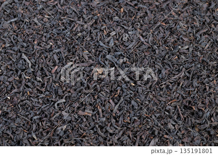 Tea leaf textures, Highresolution image of loose black tea leaves on neutral background, Detailed shot emphasizing curled texture and matte finish of Ceylon black tea leaves Tea leaf textures, Highresolution image of loose black tea leaves on neutral background, Detailed shot emphasizing curled texture and matte finish of Ceylon black tea leaves 135191801