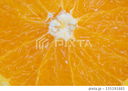 Vibrant orange fruit image, High contrast photograph emphasizing pulp and juice texture, Detailed closeup capturing vibrant color and texture of fresh orange interior 135191881
