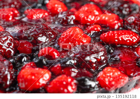 Sweet raspberry jam sensation, Delightful dessert with berries and glossy glaze, Comforting baked dessert showcasing ripe raspberries covered in shiny sticky jam coating 135192118