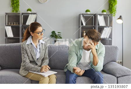 Emotional support from therapist to man during counseling session in clinic 135193807