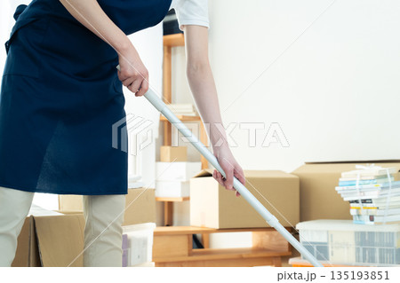 片付けと掃除をする女性 135193851