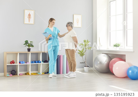 Senior health care and rehabilitation, physical therapist, nurse or sport instructor at session 135195923