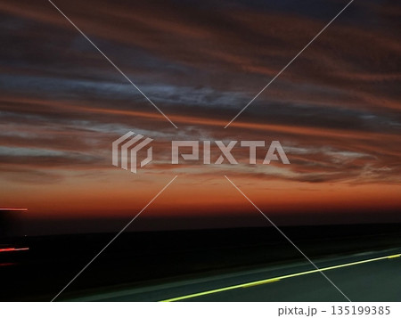 Serene sunset sky over the cityscape, where soft blue and warm orange hues blend beautifully. Silhouetted buildings glow gently as day turns to night, creating a calm and dreamy urban view. Serene sunset sky over the cityscape, where soft blue and warm orange hues blend beautifully. Silhouetted buildings glow gently as day turns to night, creating a calm and dreamy urban view. 135199385