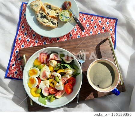 A delightful brunch spread featuring a mix of savory and sweet dishes, including fresh pastries, eggs, seasonal fruits, and a hot beverage. A perfect mid-morning indulgence. A delightful brunch spread featuring a mix of savory and sweet dishes, including fresh pastries, eggs, seasonal fruits, and a hot beverage. A perfect mid-morning indulgence. 135199386