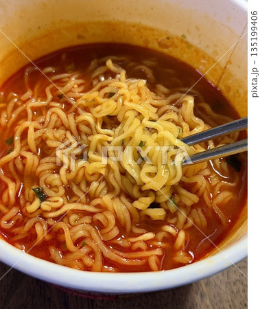 Spicy Shin ramyeon with bold, flavorful broth, served alongside fresh kimbap and tangy kimchi. A perfect trio of comforting, savory, and spicy Korean favorites in every bite. 135199406