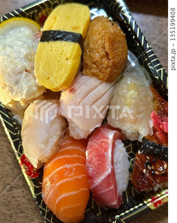 An assortment of fresh sushi, artfully arranged with a variety of toppings and vibrant colors. This traditional Japanese dish combines vinegared rice, seafood, and vegetables for an experience. 135199408