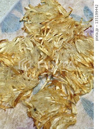 Golden-brown gamja jeon, a classic Korean potato pancake, crispy on the outside and tender inside. Simple yet flavorful, it's a comforting snack or side dish to enjoy anytime. 135199442