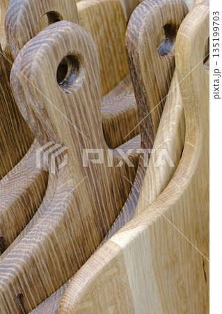 A large group of handmade wooden cutting boards 135199703
