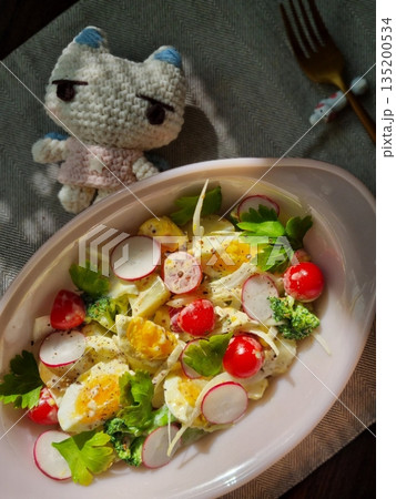 Fresh salad with a mix of crisp leafy greens, sliced vegetables, and colorful ingredients, tossed together to create a healthy, vibrant, and refreshing dish full of natural flavors 135200534