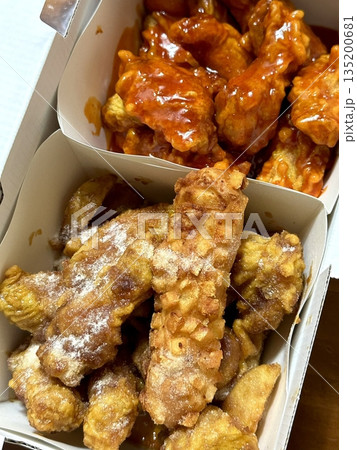 Crispy Korean fried chicken, perfectly glazed with a sweet and spicy sauce. Ideal for food photography and menus, showcasing the irresistible crunch and flavor of this beloved dish. Crispy Korean fried chicken, perfectly glazed with a sweet and spicy sauce. Ideal for food photography and menus, showcasing the irresistible crunch and flavor of this beloved dish. 135200681