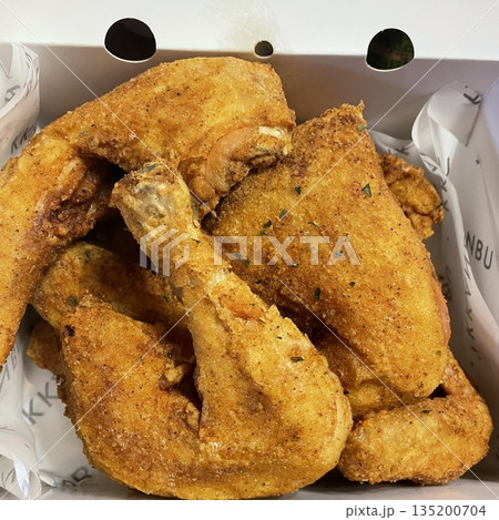 Crispy Korean fried chicken, perfectly glazed with a sweet and spicy sauce. Ideal for food photography and menus, showcasing the irresistible crunch and flavor of this beloved dish. 135200704