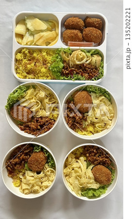 A traditional Korean dosirak, beautifully arranged with rice, assorted banchan, and savory proteins. Balanced and visually inviting, it’s a portable meal packed with vibrant flavors. A traditional Korean dosirak, beautifully arranged with rice, assorted banchan, and savory proteins. Balanced and visually inviting, it’s a portable meal packed with vibrant flavors. 135202221