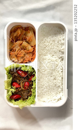 A traditional Korean dosirak, beautifully arranged with rice, assorted banchan, and savory proteins. Balanced and visually inviting, it’s a portable meal packed with vibrant flavors. 135202252
