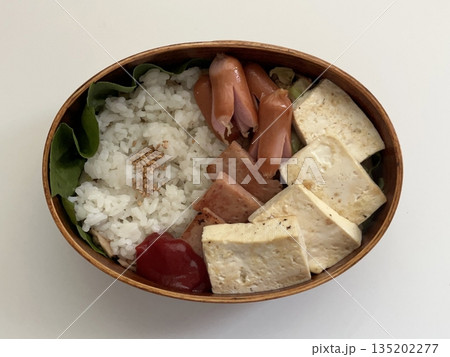 A traditional Korean dosirak, beautifully arranged with rice, assorted banchan, and savory proteins. Balanced and visually inviting, it’s a portable meal packed with vibrant flavors. A traditional Korean dosirak, beautifully arranged with rice, assorted banchan, and savory proteins. Balanced and visually inviting, it’s a portable meal packed with vibrant flavors. 135202277