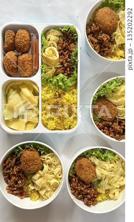 A traditional Korean dosirak, beautifully arranged with rice, assorted banchan, and savory proteins. Balanced and visually inviting, it’s a portable meal packed with vibrant flavors. A traditional Korean dosirak, beautifully arranged with rice, assorted banchan, and savory proteins. Balanced and visually inviting, it’s a portable meal packed with vibrant flavors. 135202292