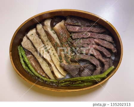 A traditional Korean dosirak, beautifully arranged with rice, assorted banchan, and savory proteins. Balanced and visually inviting, it’s a portable meal packed with vibrant flavors. 135202313