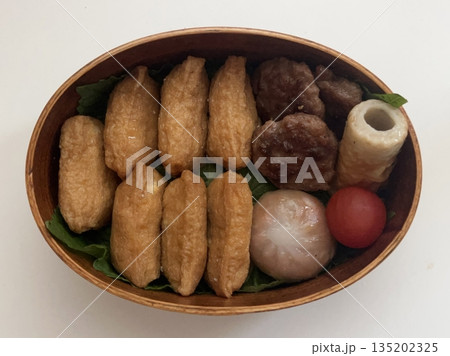 A traditional Korean dosirak, beautifully arranged with rice, assorted banchan, and savory proteins. Balanced and visually inviting, it’s a portable meal packed with vibrant flavors. 135202325