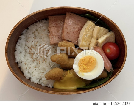 A traditional Korean dosirak, beautifully arranged with rice, assorted banchan, and savory proteins. Balanced and visually inviting, it’s a portable meal packed with vibrant flavors. A traditional Korean dosirak, beautifully arranged with rice, assorted banchan, and savory proteins. Balanced and visually inviting, it’s a portable meal packed with vibrant flavors. 135202328