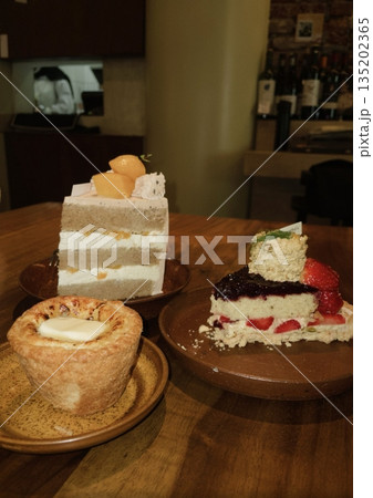 Refreshing ice americano and soft strawberry roll cake with creamy filling served on a cozy café table, offering a perfect mix of bold coffee and sweet indulgence in every peaceful bite and sip. Refreshing ice americano and soft strawberry roll cake with creamy filling served on a cozy café table, offering a perfect mix of bold coffee and sweet indulgence in every peaceful bite and sip. 135202365