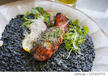Squid Ink Risotto Topped with Grilled Calamari 135203735