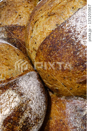Group of traditional round loaves of dark rye bread Group of traditional round loaves of dark rye bread 135203867