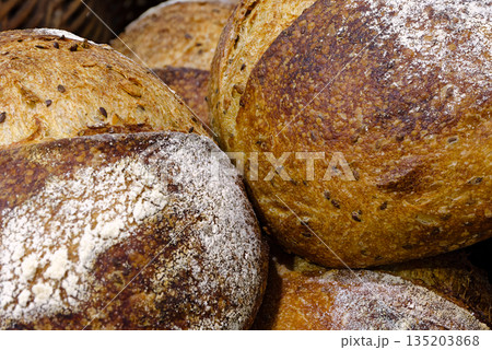 Group of traditional round loaves of dark rye bread 135203868