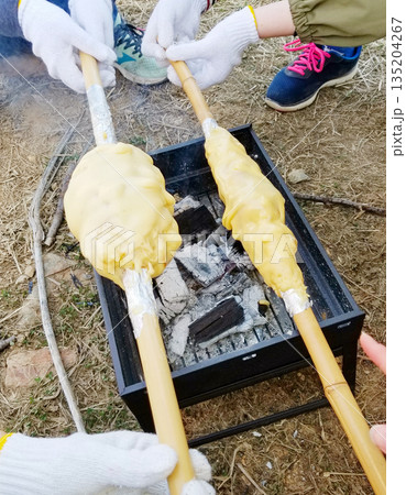 竹竿バウムクーヘンを焼く子供 135204267
