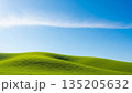 Vast green hills meet clear blue sky with thin cloud, symbolizing tranquility and natural beauty for spring and summer background. 135205632