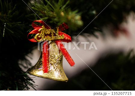 Festive holiday decoration, Sparkling holiday bell adorned with greenery and cheerful lettering 135207715