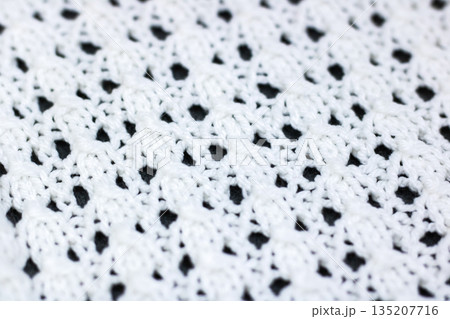 Close inspection highlighting craftsmanship and textural patterns in cotton crochet textile 135207716