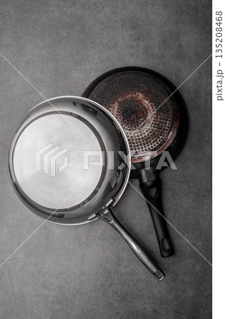 Vintage kitchen scenes, Rustic cookware with signs of frequent use, Weathered pots and pans with stains and patina evoke nostalgic kitchen memories and timeless stories 135208468
