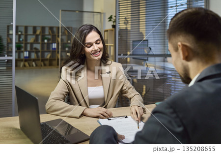 Bank consulting as business client signs contract with financial manager in office 135208655