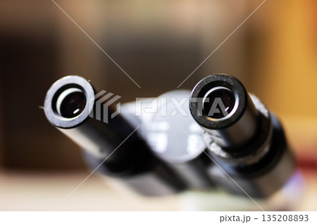Microscope parts with ambient lighting, Closeup of advanced optical instrument details 135208893