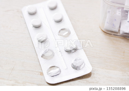 Medical environment showing prescription containers and organized pills for adherence 135208896