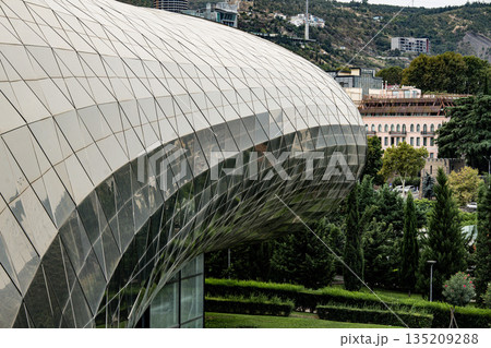 Modern Architecture Of The Bridge Of Peace And Glass Structures In Central Tbilisi Georgia: Contemporary Design Amidst Greenery And Historic Urban Landscape 135209288