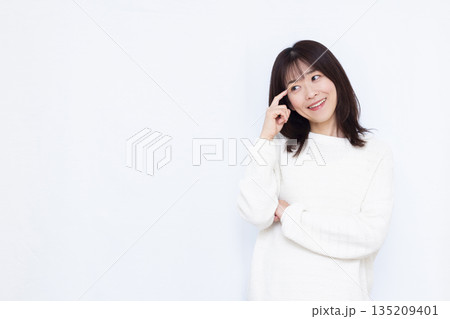 頭を抱えて考えている女性 135209401