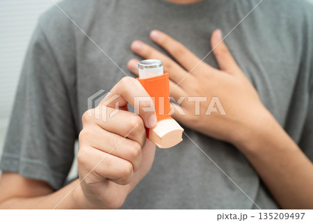 Asthma and chronic obstructive pulmonary disease COPD, Asian teenage using metered dose inhaler MDI. Asthma and chronic obstructive pulmonary disease COPD, Asian teenage using metered dose inhaler MDI. 135209497