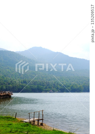 Beautiful landscape rivers and valley mountains and Rustic wooden bridge on riverbank for travel in Thailand 135209517