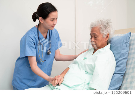 Asian doctor checking and treat elderly woman patient health in hospital. Asian doctor checking and treat elderly woman patient health in hospital. 135209601