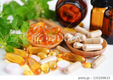 Alternative medicine herbal organic capsule with vitamin E omega 3 fish oil, mineral, drug with herbs leaf natural supplements for healthy good life. Alternative medicine herbal organic capsule with vitamin E omega 3 fish oil, mineral, drug with herbs leaf natural supplements for healthy good life. 135209615