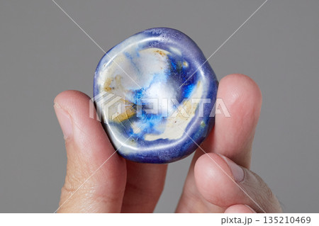 worry stone healing on gray background worry stone healing on gray background 135210469